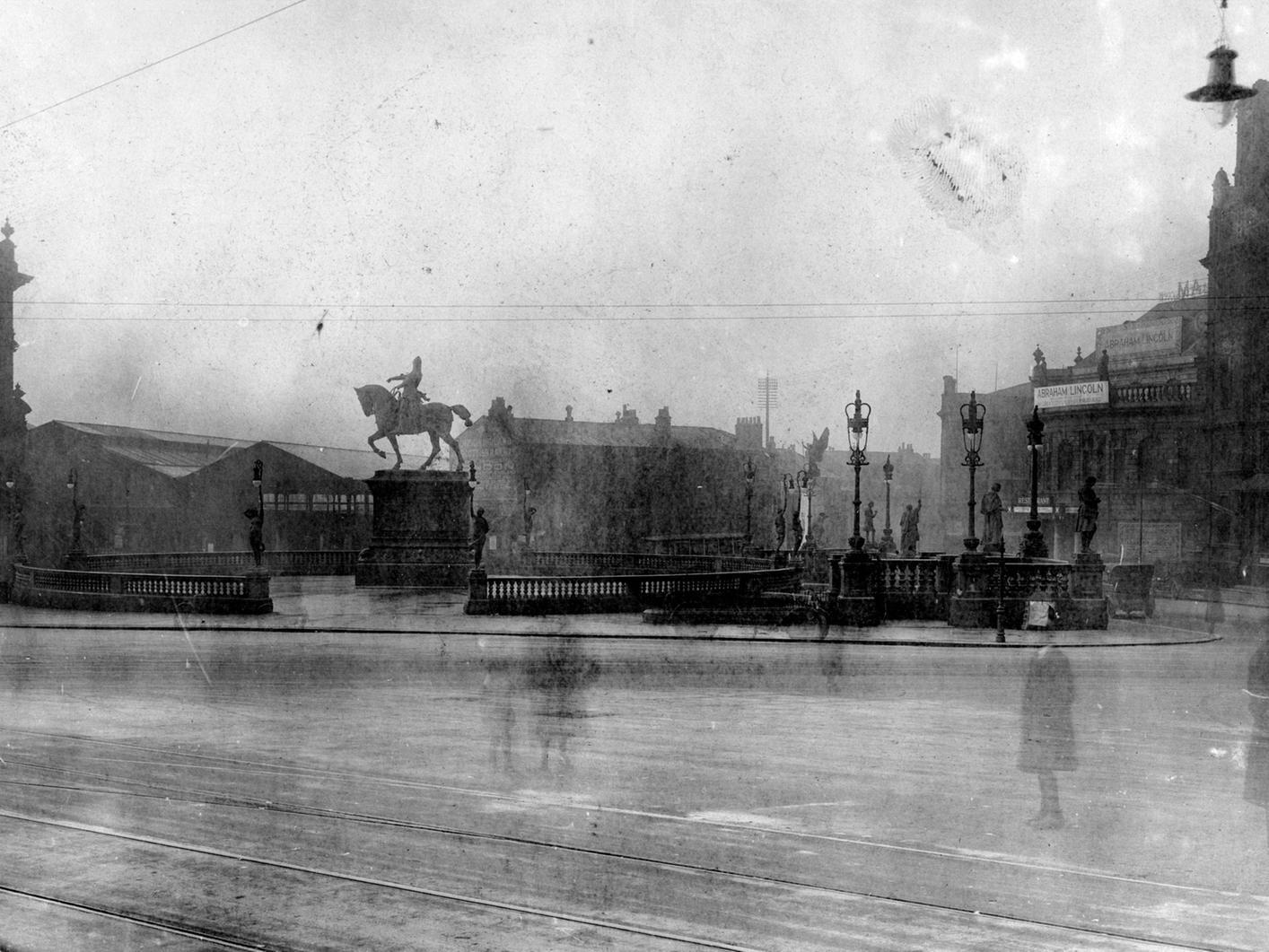 A view across City Square, showing from left to right. Old Queen's Hotel, Railway Station, Wellington Street, Majestic and Post Office.