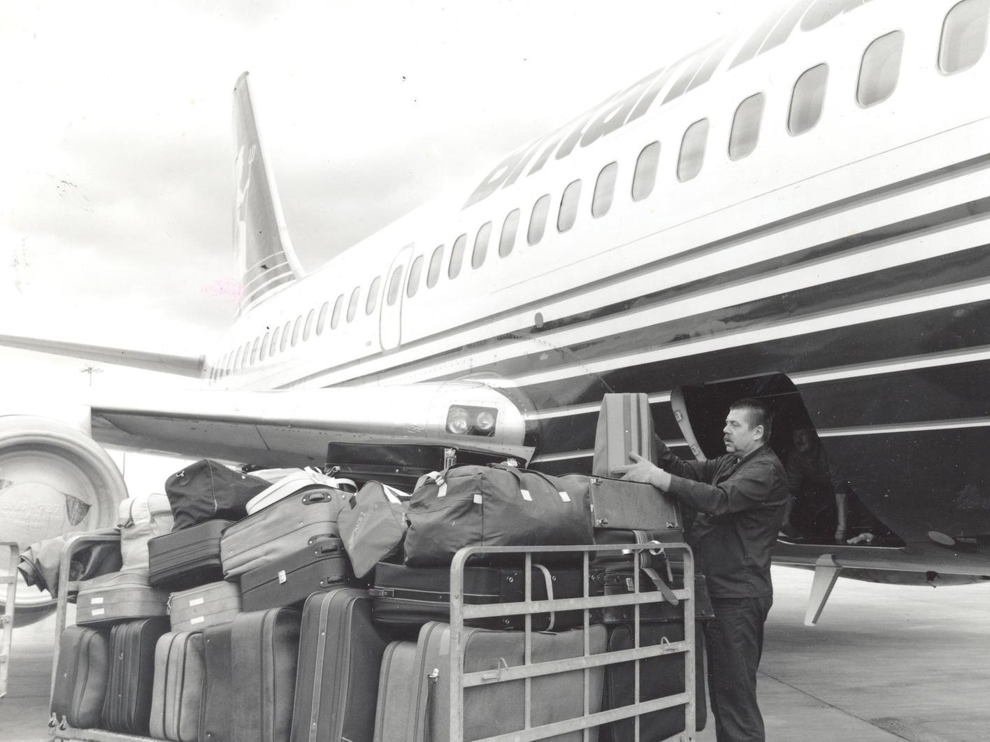 Baggage is loaded onto a holiday flight.