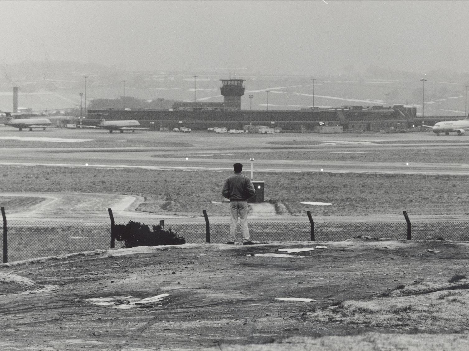 A plane spotter looks across to Leeds Bradford Airport.