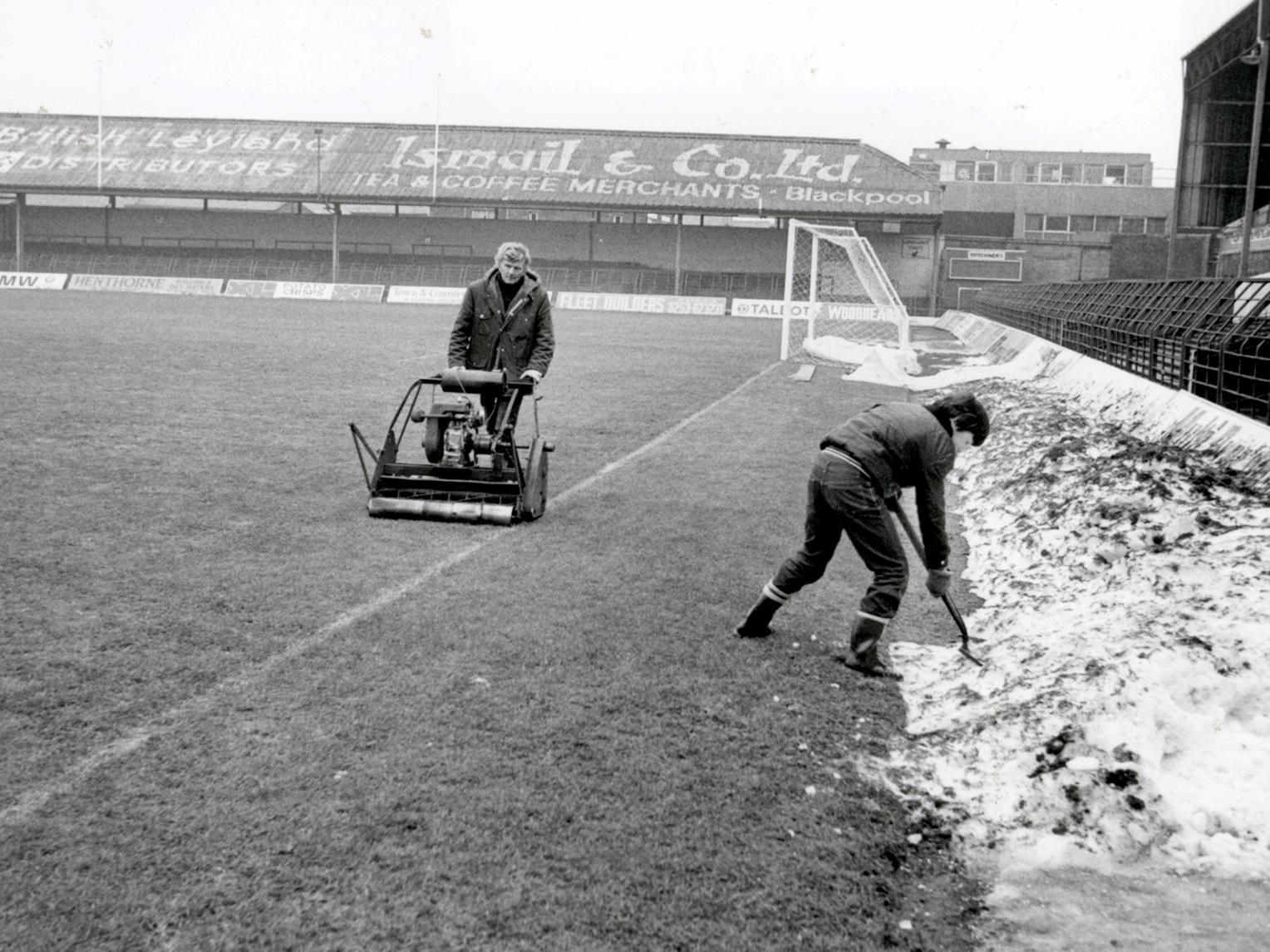 The remaining drifts of snow are cleared away from the surrounding track on Decemebr 30 1981. Blackpool FC and groundsman Cyril Robinson gives the grass a trim at Bloomfield Road.