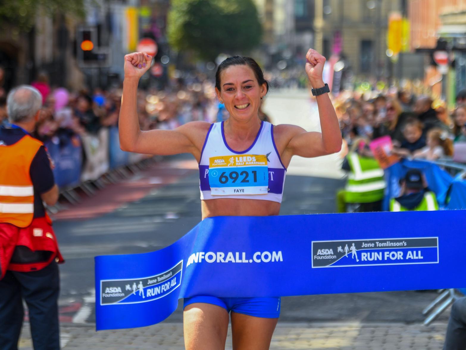 Runner Faye Banks crosses the finish line of the Leeds Half Marathon in May last year