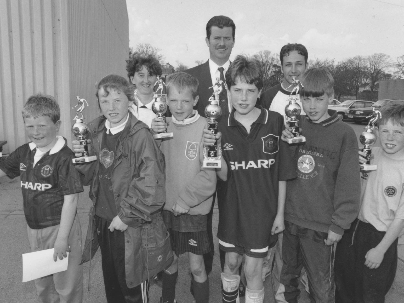 Pictured with their performance related trophies after attending the Scarborough FC Football in the Community Fun Week in April 1994 are, left to right, James Taylor, Mary Jane Alexander, Ben David, Nick Wilkinson, Philip Nockels and John Heron. Also pictured, back left to right, Fun Week officer Gail Colling, sponsor Mark Harford of Arundale and Kieron Heblich.