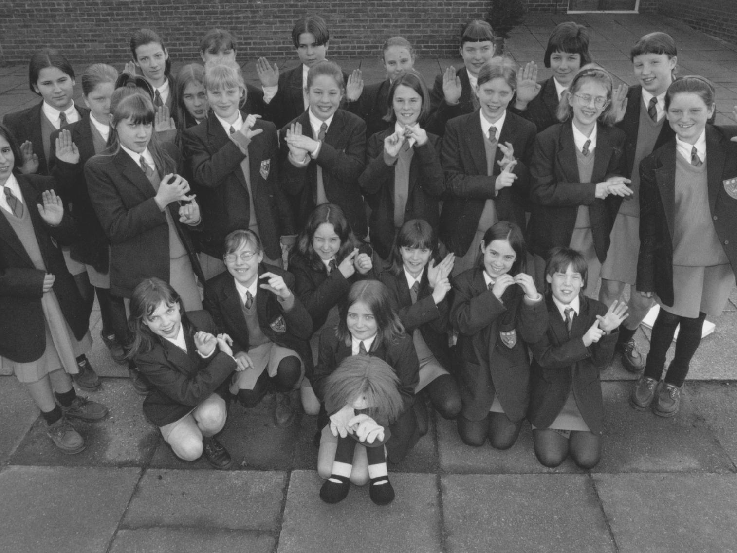 Pupils from the signing class at Scalby School are pictured signing, from the front, the Scalby School Welcome, in March 1997. At the front is Molly, a doll which pupils used like a puppet to help them learn sign language.