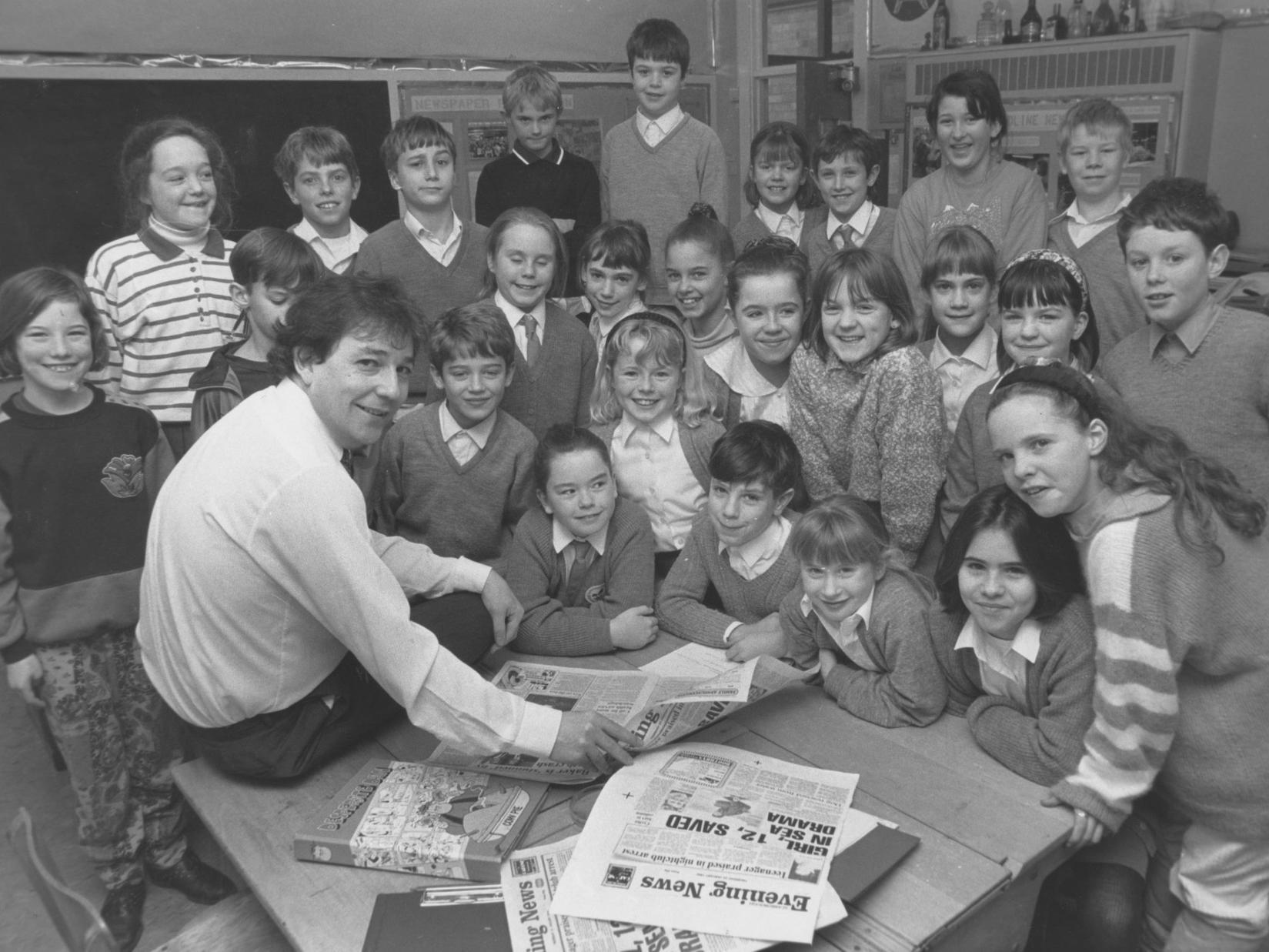 Editor of the Scarborough Evening News, Neil Speight, is pictured with pupils from class 5 at Wheatcroft School who were doing a topic on communications for the winter term. Photo taken in January 1992.
