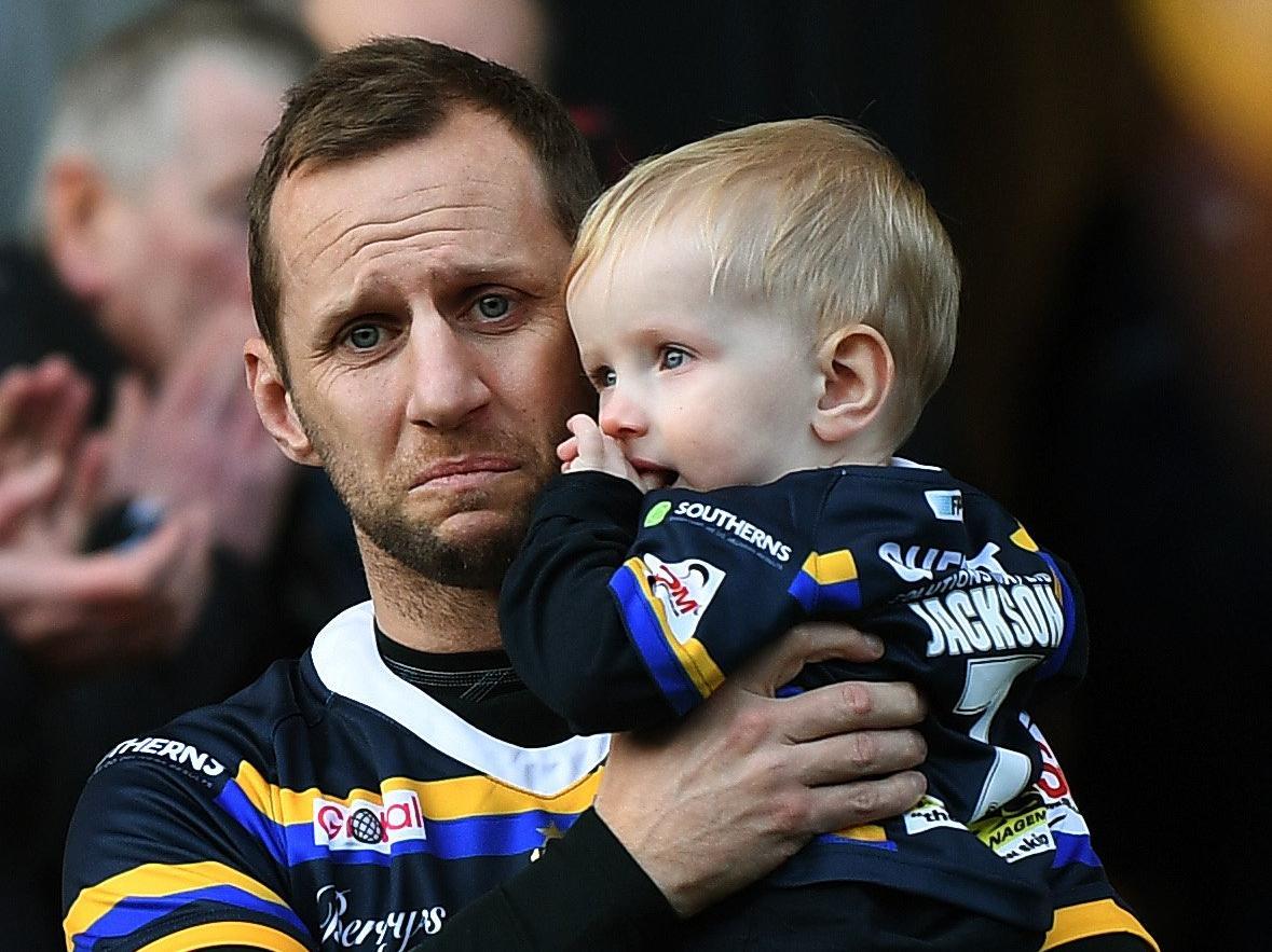 An emotional Rob Burrow on the pitch with his son Jackson.
