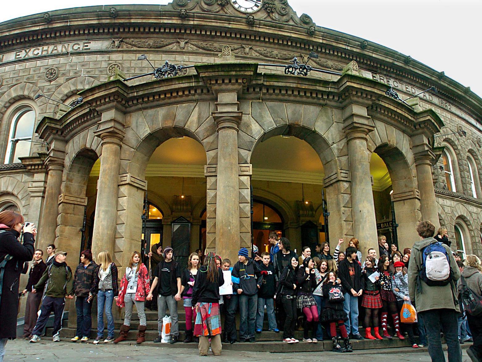 Youngsters form a chain of hands around the main entrance to Corn Exchange over the proposed closure of shops.