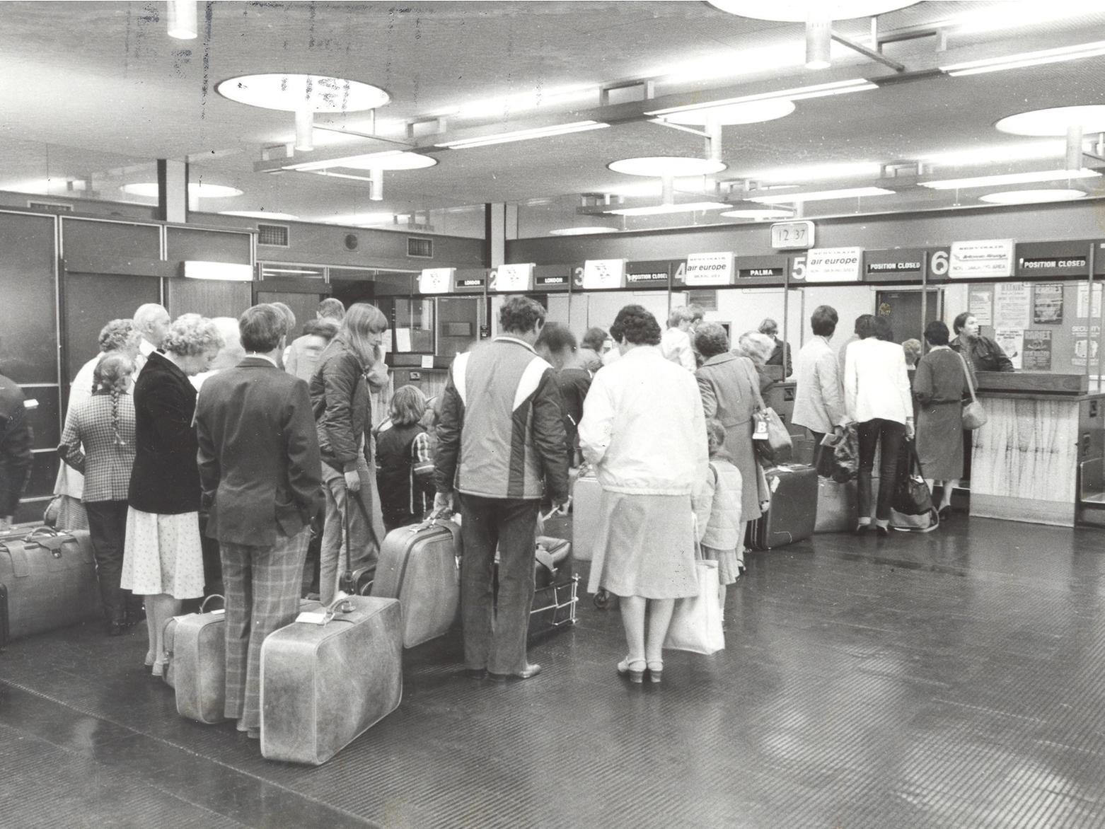 Passengers queue at check in for a flight from Leeds Bradford.