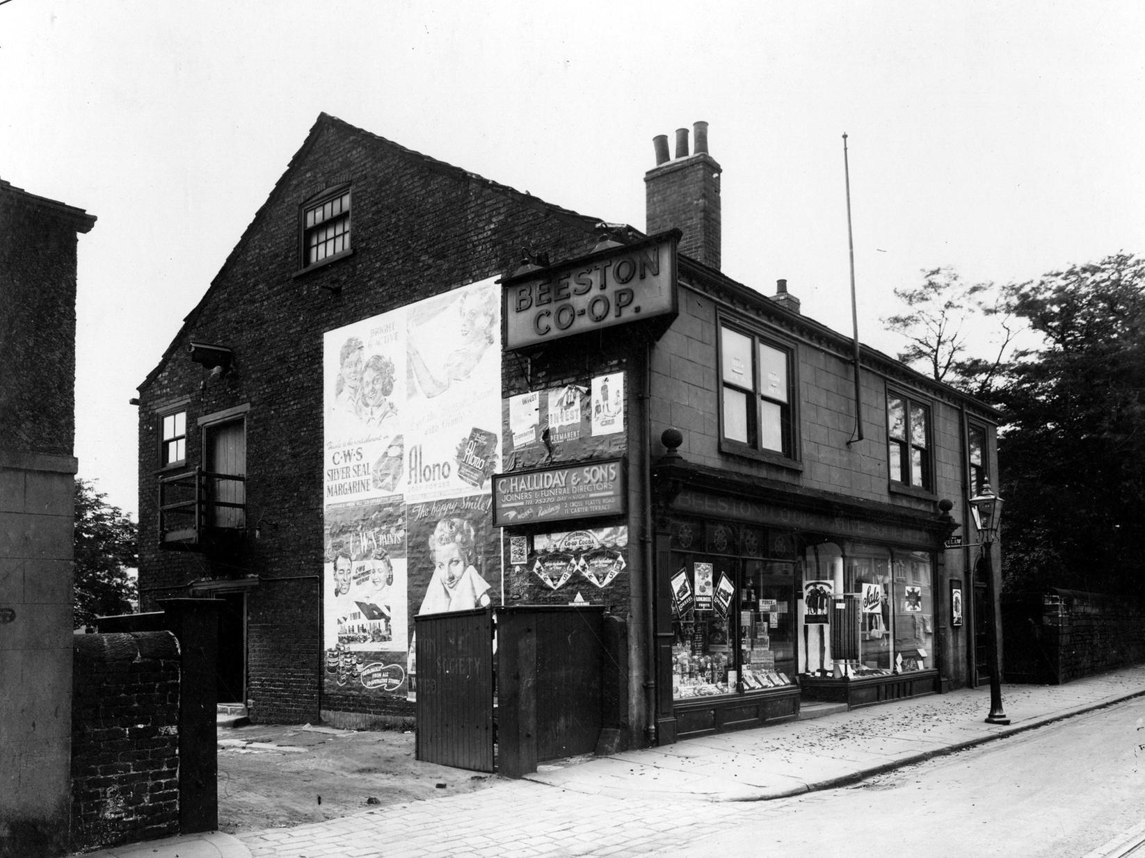 A view of Beeston Co-operative Society which was at 79 Town Street. The entrance to yard of C.Halliday & Sons, Joiners and Funeral Directors can be seen on the left.