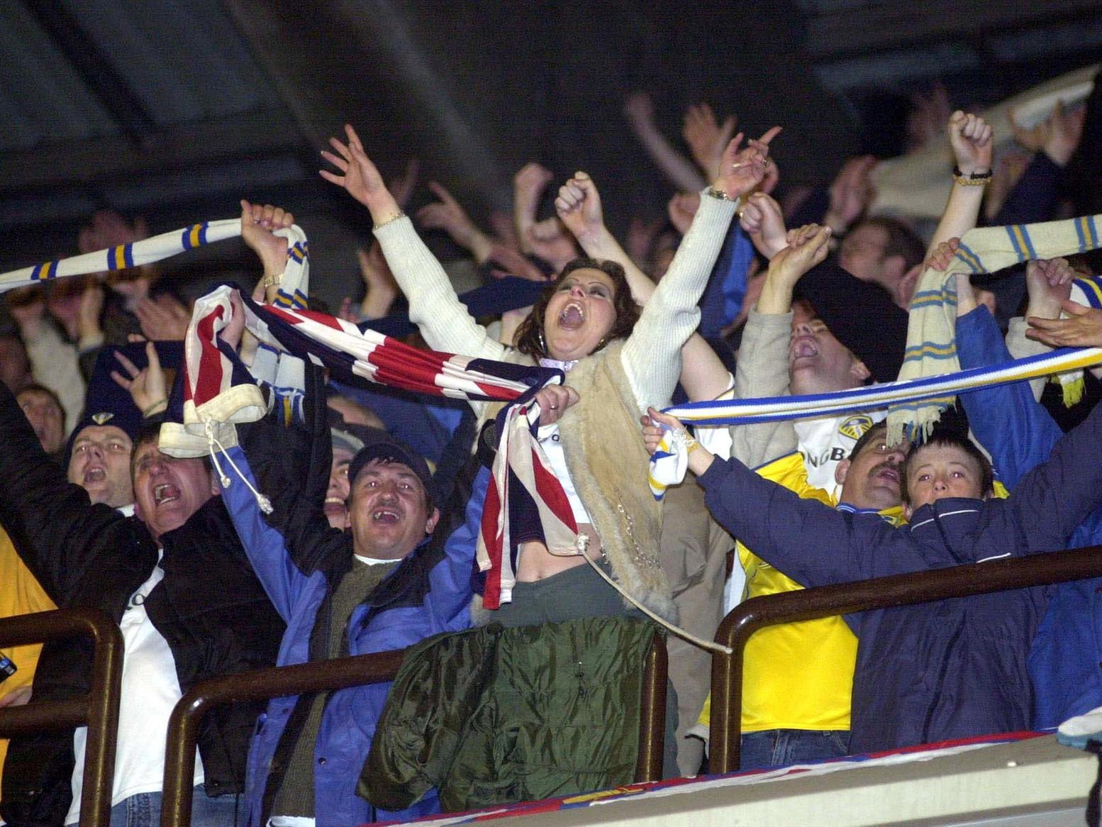 Leeds United fans celebrate Champions League victory against RSC Anderlecht at the Vanden Stock Stadium in Brussels.