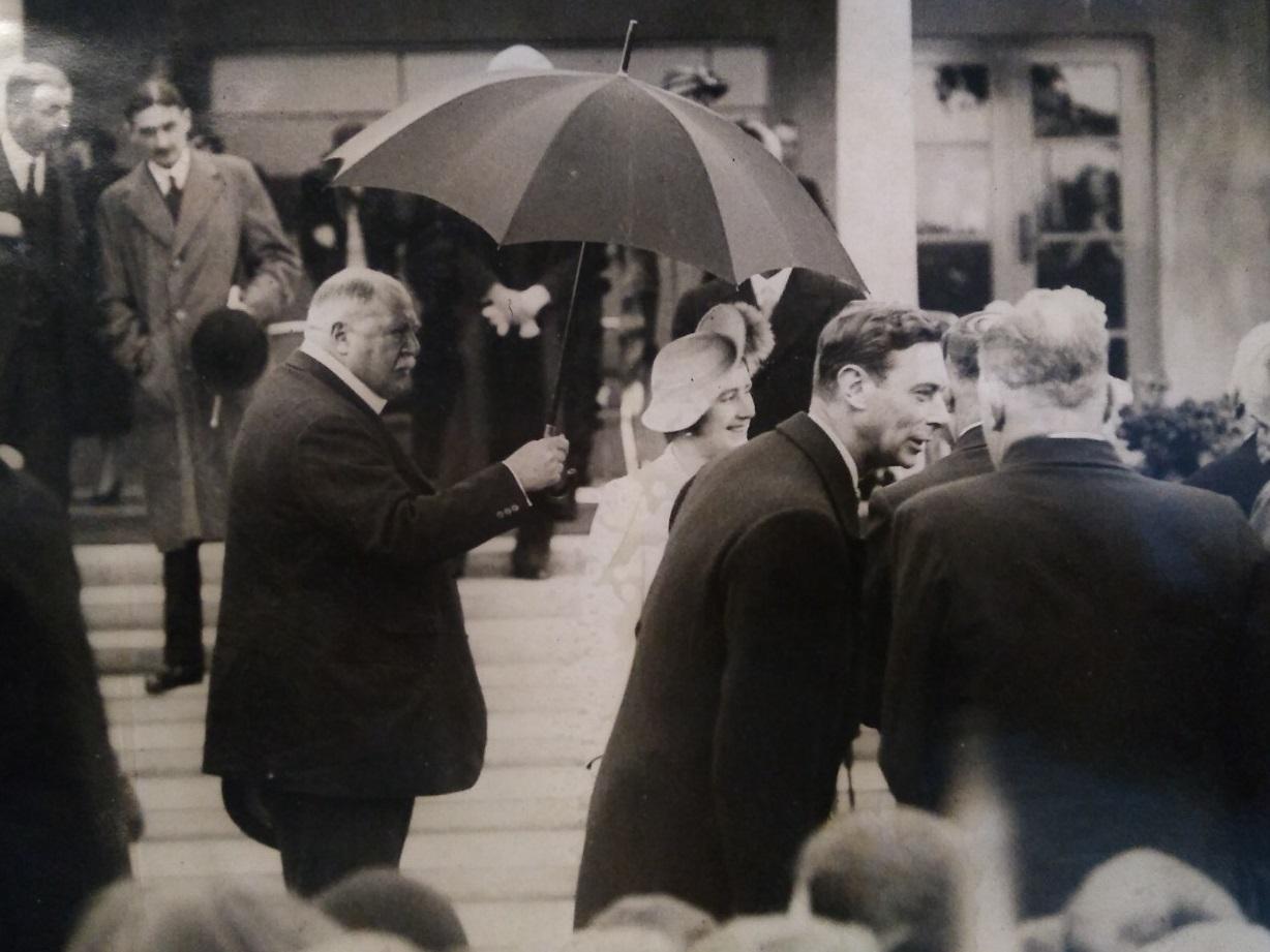 King George IV and Queen Elizabeth chat with ex-servicement in the rain during their visit to Fleetwood in 1938. Lord Derby holds the umbrella over the queen.