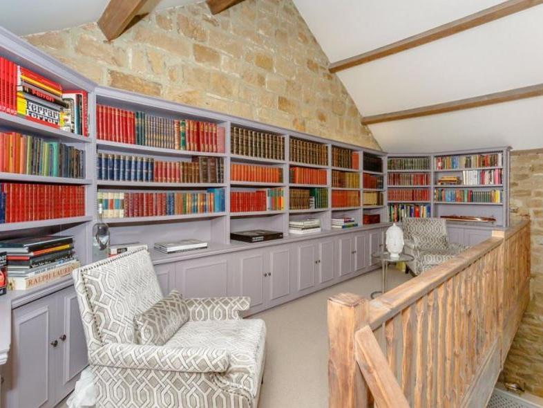 From the dining room sits a cosy, fitted library with extensive book shelving, and it is set around a central galleried landing overlooking the drawing room.