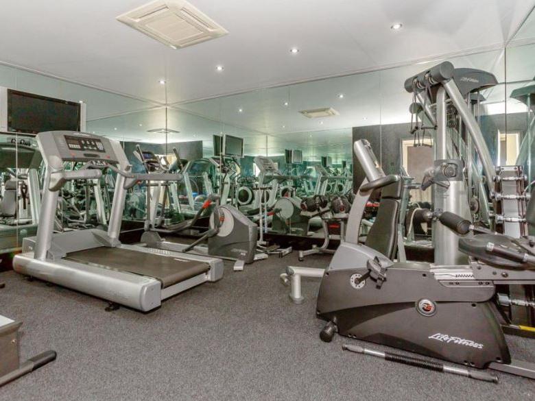 An inner lobby provides access to an air conditioned gymnasium, complete with mirrored walls, a treadmill, cross trainer and weight machines, among others.
