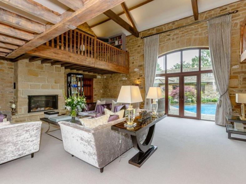 The lounge area has been stylishly furnished and boasts a feature stone fireplace with remote controlled inset gas fire, exposed stone walling and exposed beams overhead.