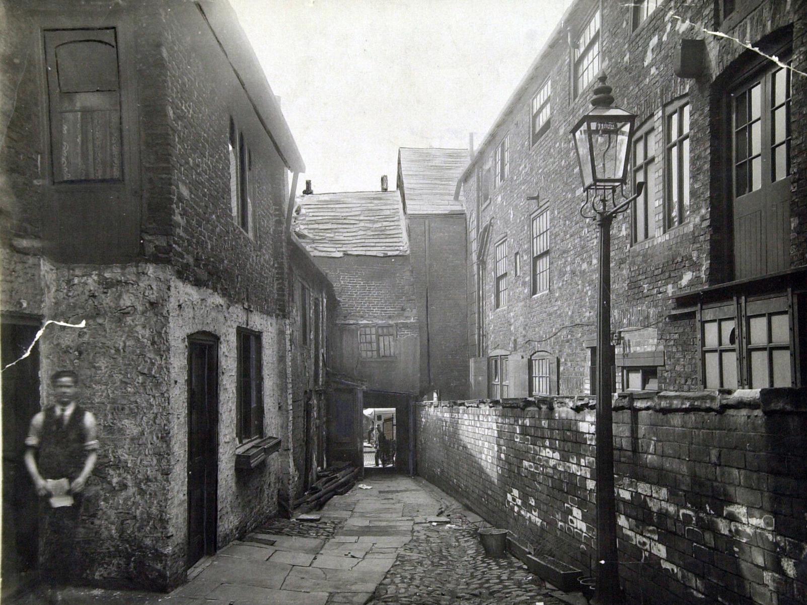 This is King's Arms Yard off Lower Headrow. The narrow alley over the wall was Atkinsons Court. This would be part of the site on which the Odeon Cinema would be built.