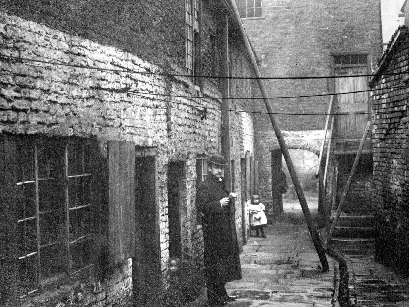 Cherry Tree Yard off Kirkgate, shows narrow alleyway. A man and child can be seen posing for the photograph which is looking north.