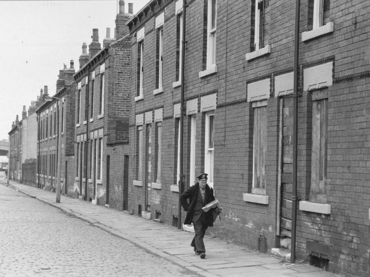 A postman makes his deliveries in Holbeck in 1979.