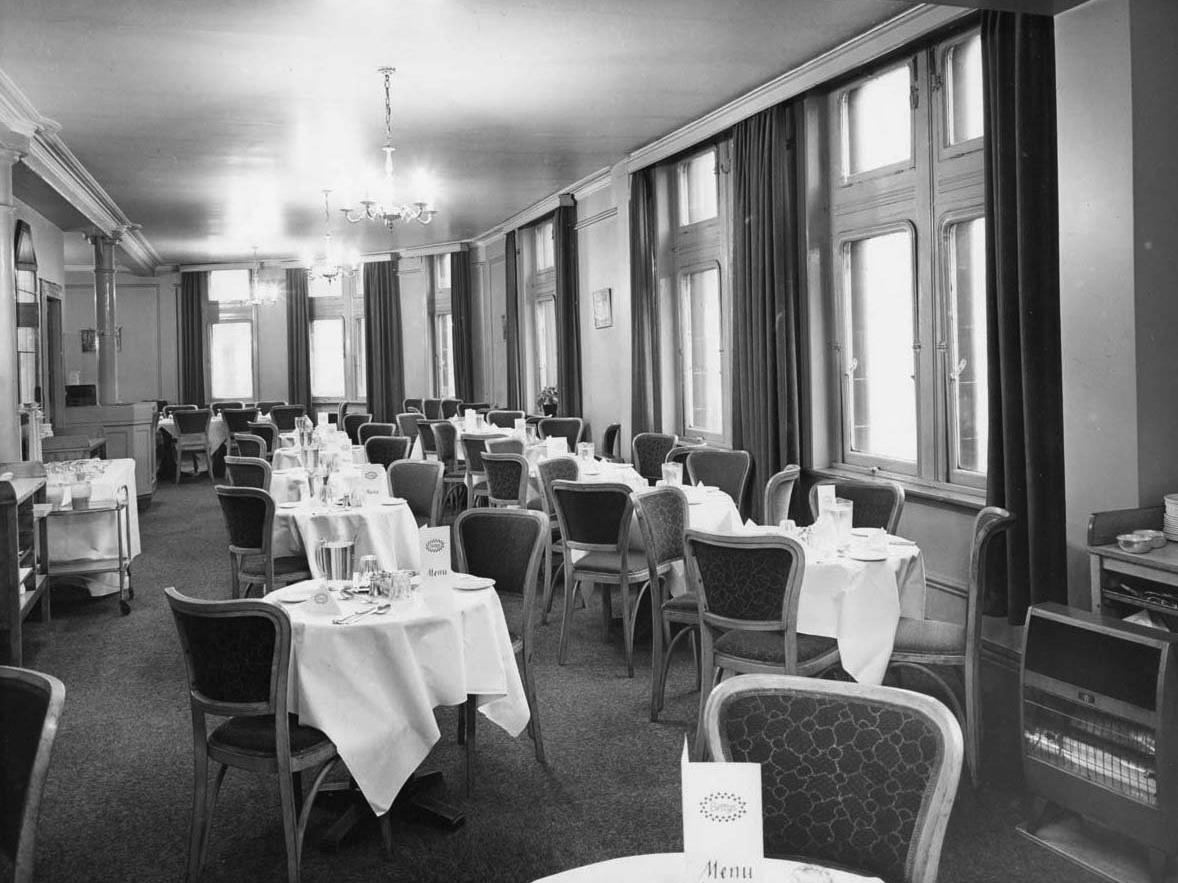 The first floor cafe, serving morning coffee afternoon tea and light lunches, was decorated in an ivory and   blue colour scheme with blue-tinted mirrors.