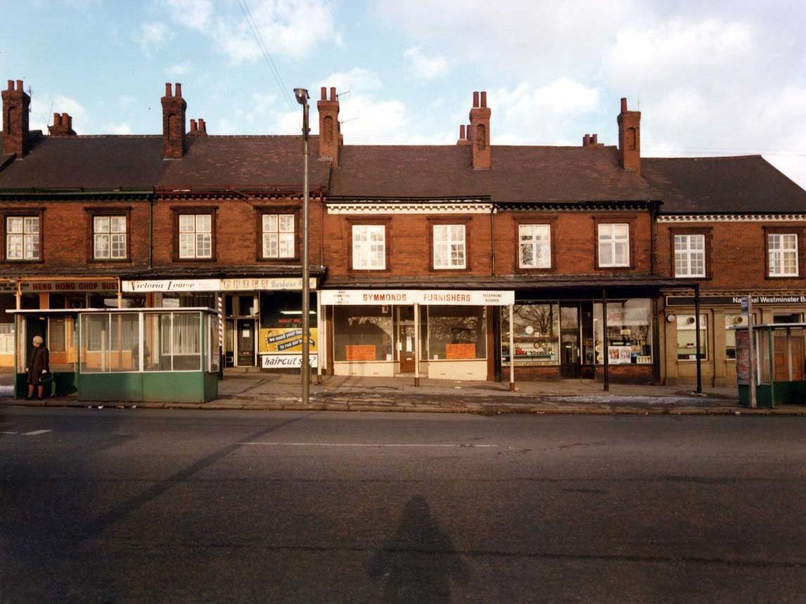 A row of shops on Harrogate Road. From left, Heng Hong Chop Suey Chinese takeaway, Victoria Louise ladies' hairdresser and Phil's barber's shop, Symmonds Furnishers, H. Pounder, jeweller and National Westminster Bank.