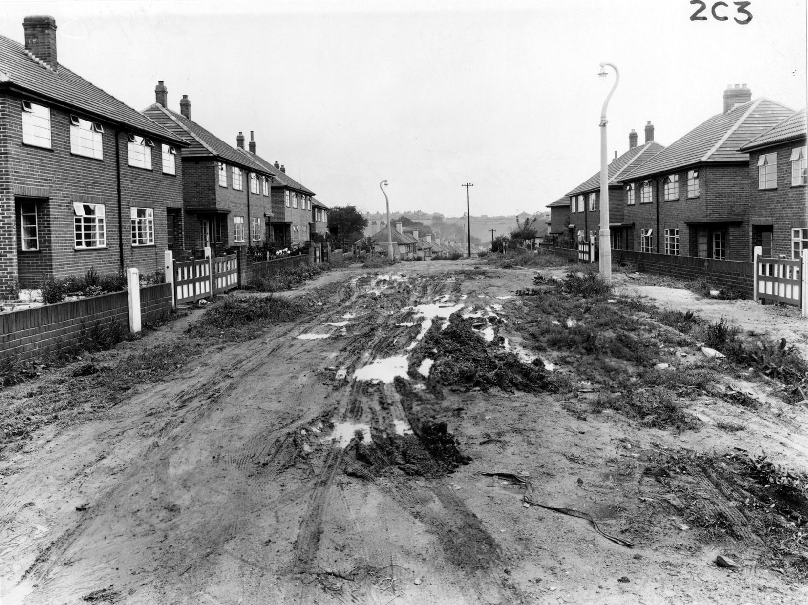 Recently built houses on Allerton Grange Rise in Moortown. The road is unmade.