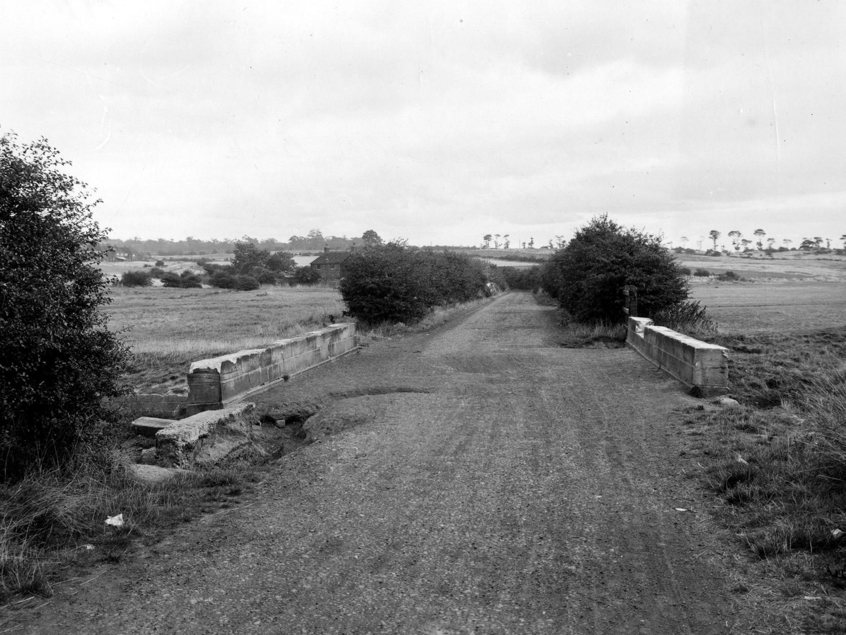 The bridge on Halton Moor Road with Wyke Beck passing underneath it. An old farmhouse can be seen to the far middle left of the picture. It was later demolished and the land used for stables for a while but is now waste land.