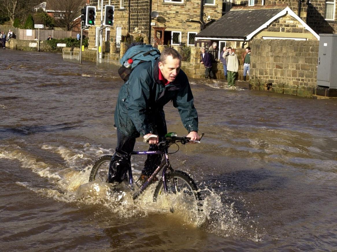 Heavy rain brought flooding chaos to Otley. This cyclist attempts to travel down Bridge Street in the market town.
