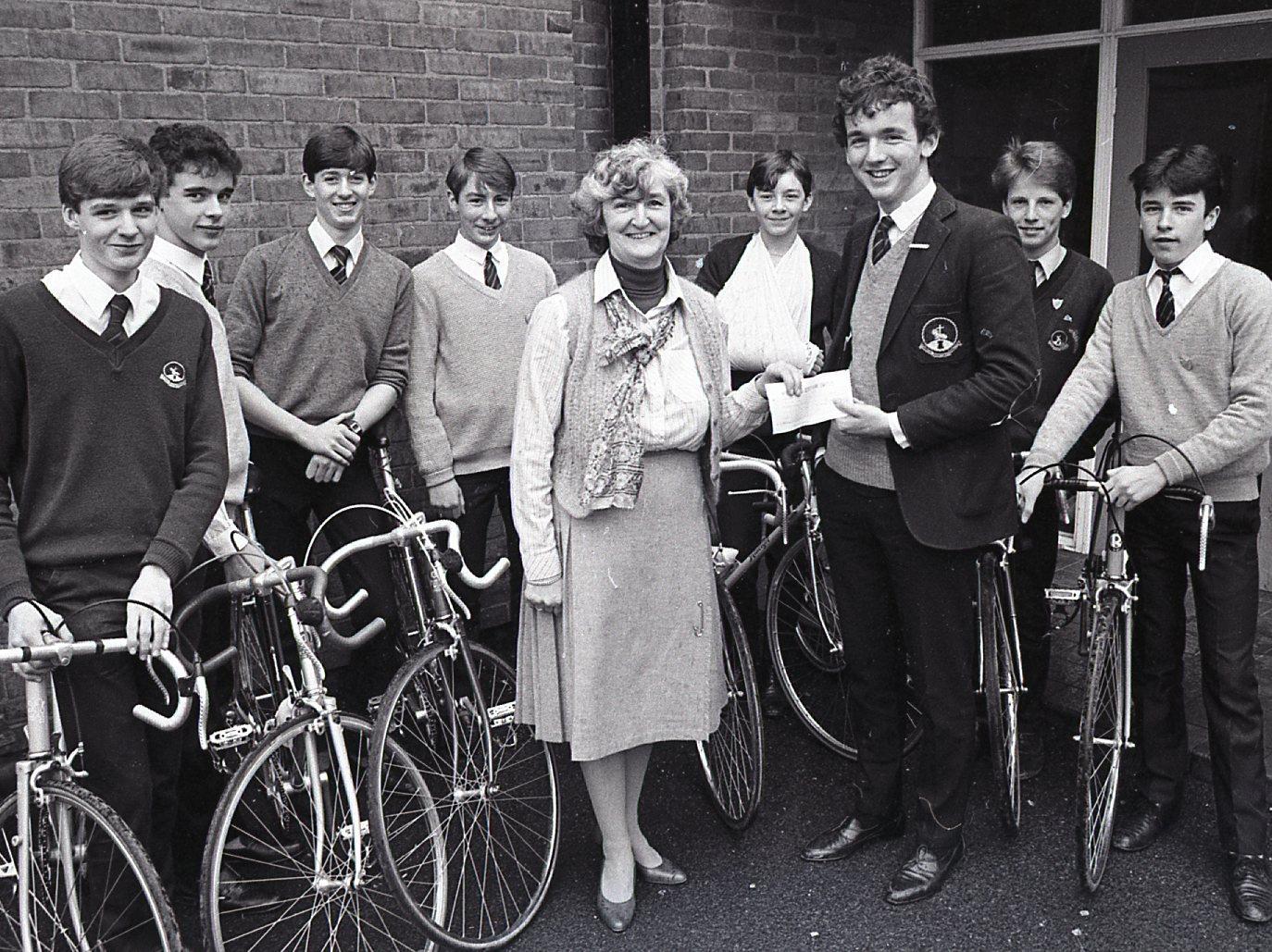 Nine fifth formers from St. Cuthbert Mayne High School, Preston, presented Mrs Margaret O'Donoghue, secretary of the St. Catherine's Hospice Appeal, with a cheque for 185 after completing a cycle ride. Presenting the cheque is the deputy head boy Howard Martin, with, from left, David Cracknell, Michael Laytham, Martin Harris, Nigel Geraghty, Gary Singleton, Chris Stephenson and John Sharples. Richard Ibison, who also rook part in the sponsored ride, is missing from the photograph