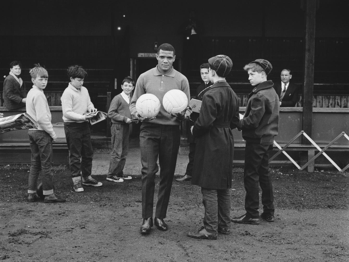 South African footballer Albert Johanneson with fans at the Hendon Football Club ground, London, during a team training session before the FA Cup final against Liverpool.