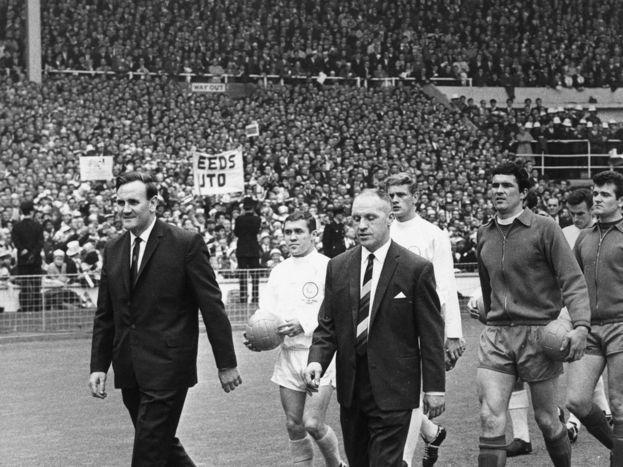 Liverpool manager Bill Shankly (1913 - 1981) and Leeds United manager Don Revie ( 1927 - 1989) lead their teams out at Wembley Stadium, London, for the 1965 FA Cup Final