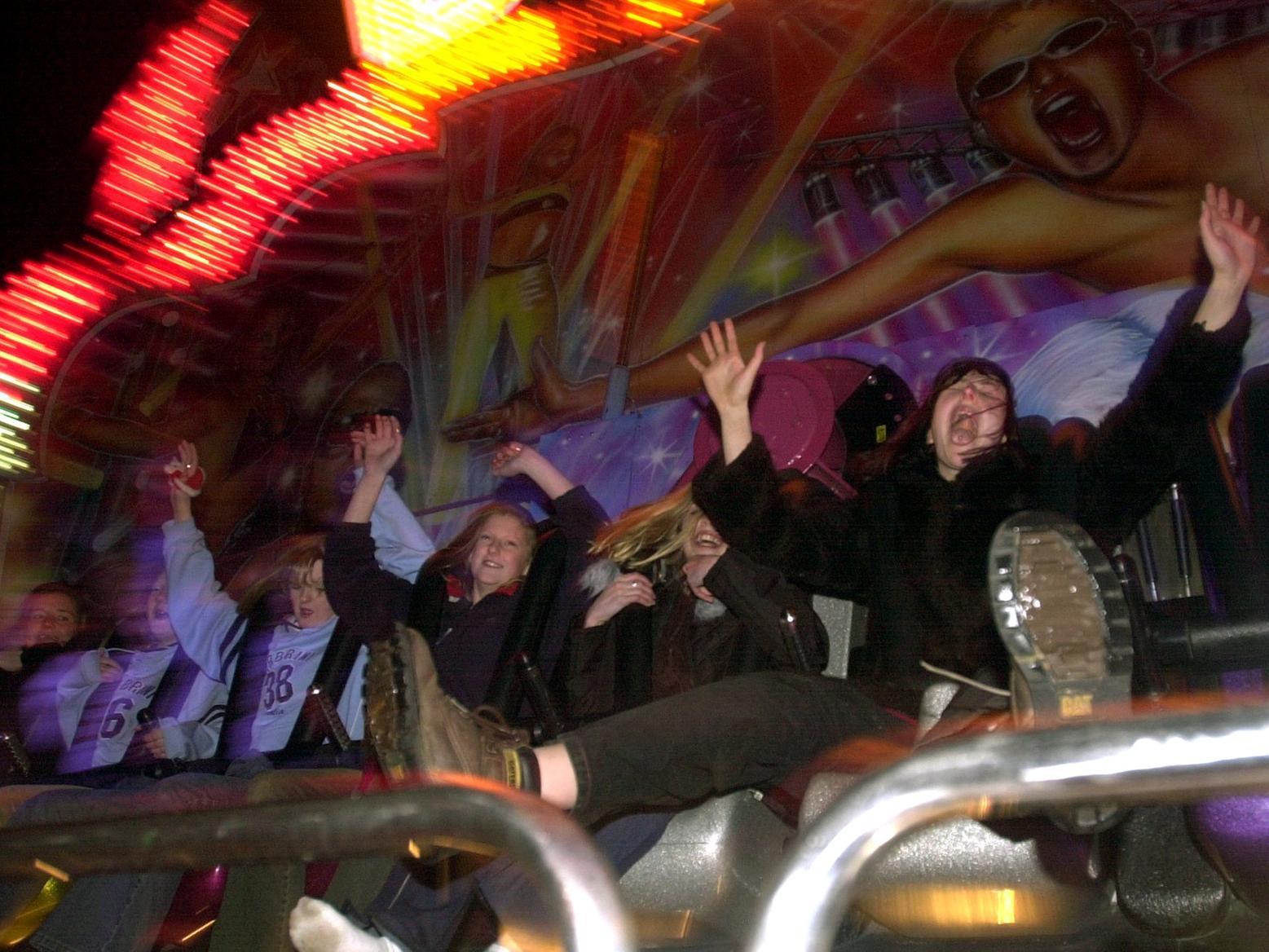 Revellers enjoy themselves on the 'Disco Fever' ride on New Year's Eve in the city centre.