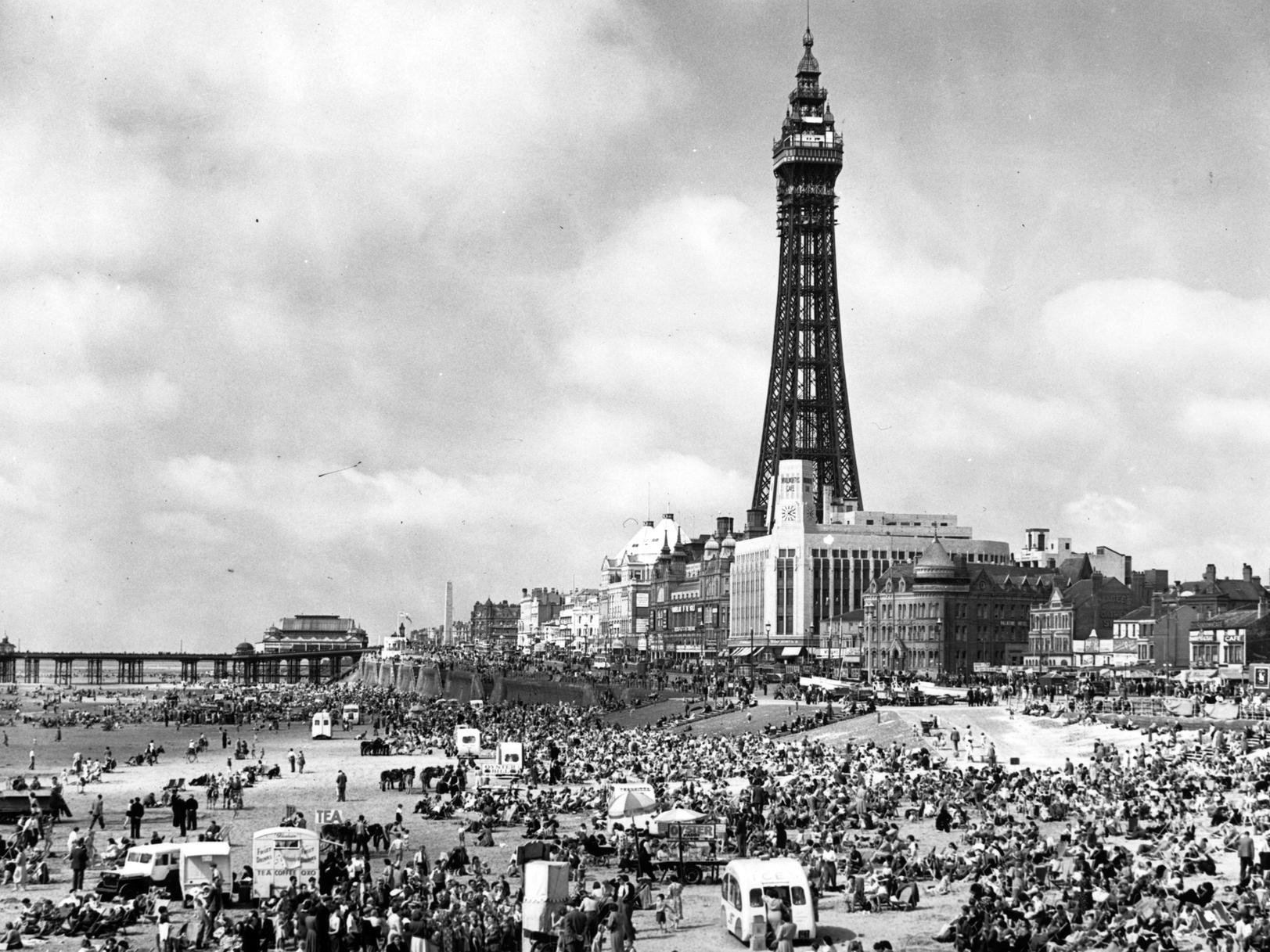 Crowds of holiday-makers on the beach at Blackpool, Lancashire, dominated by the Blackpool Tower on July 18, 1951