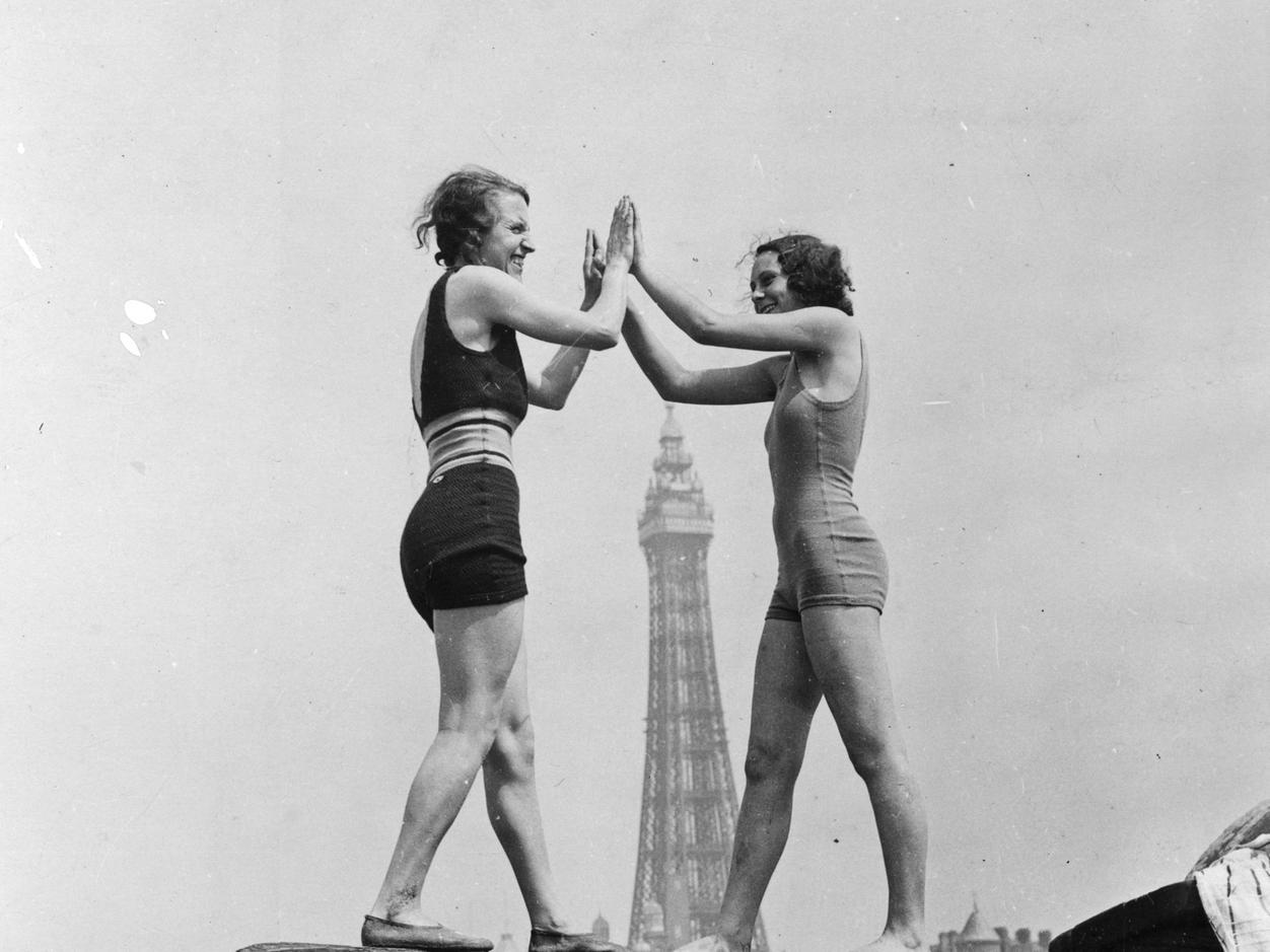 Two holidaymakers enjoying the heatwave on the beach at Blackpool July 10 1934