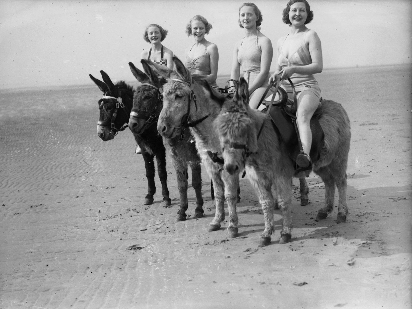 Holidaymakers riding donkeys on the beach at Blackpool, May 1936