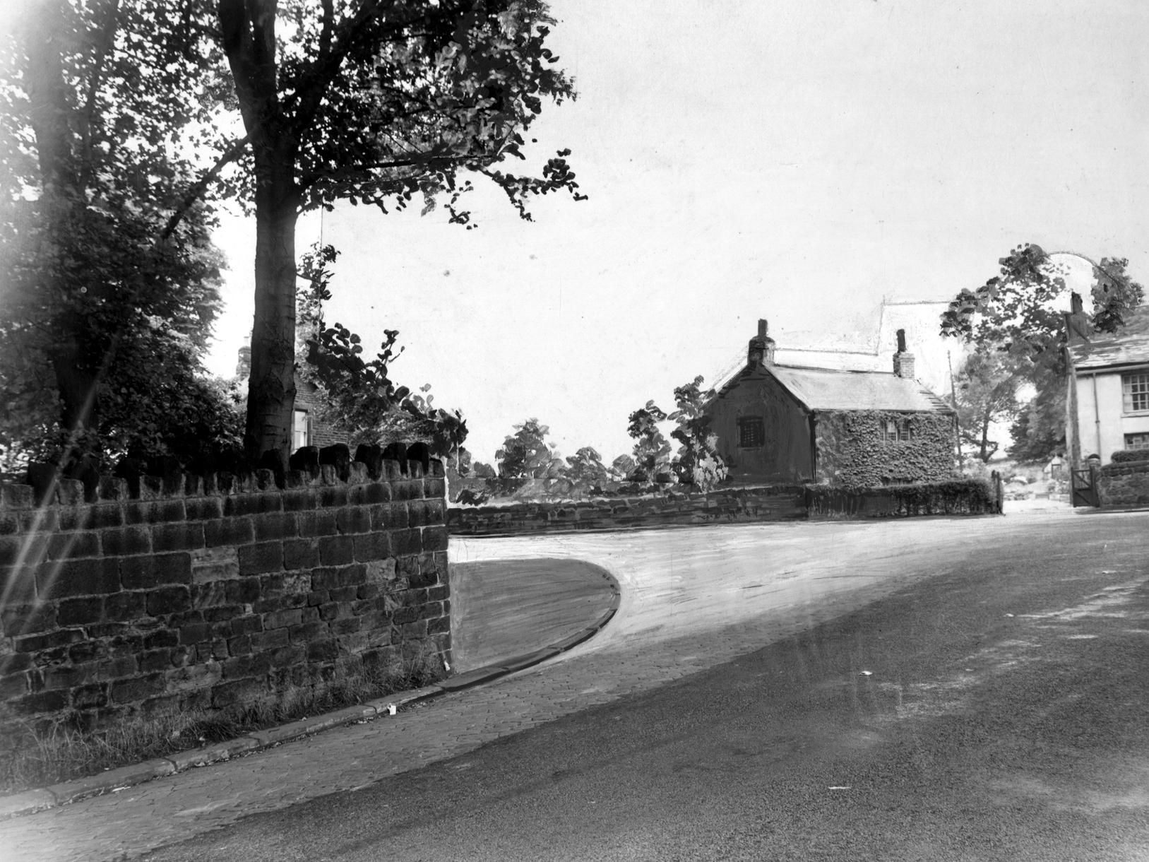 Junction of Spen Lane and Abbey Walk in Kirkstall. The photograph has the proposed widening painted onto it to show how it will look. The white rendered house on the far right is the end of a row of cottages known as Hark to Rover.