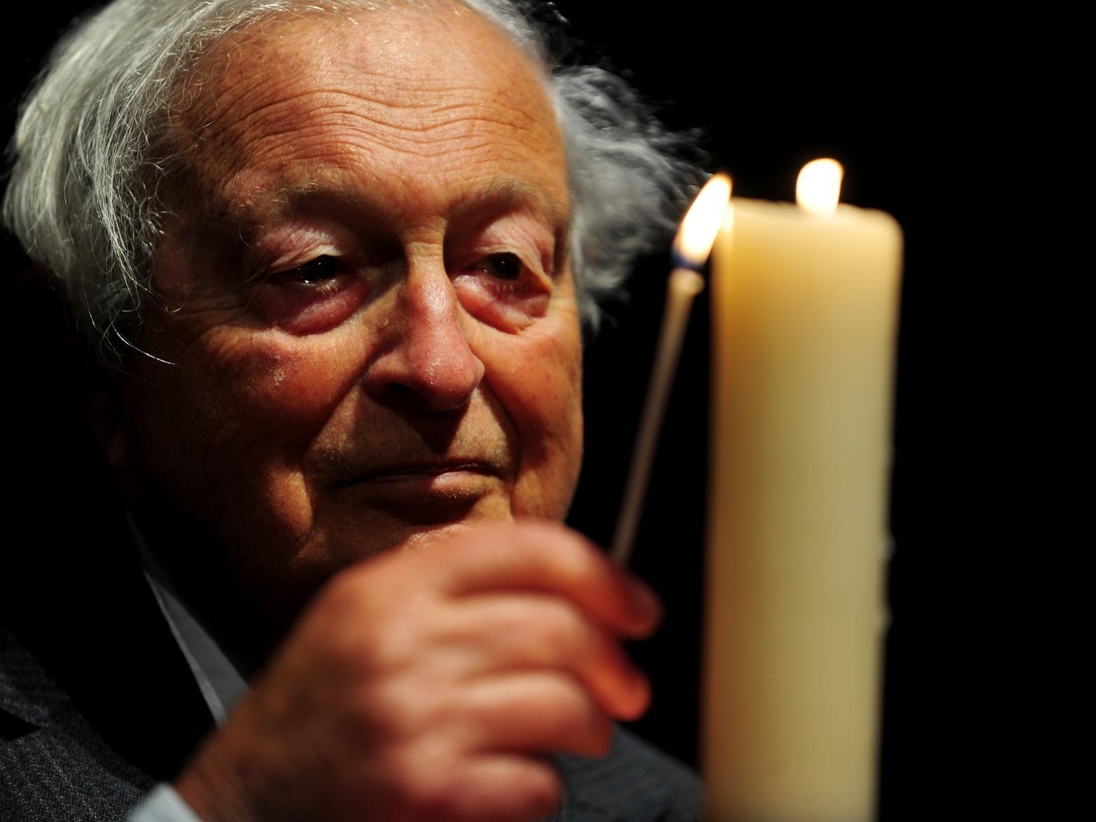 Dr Rudi Leaver lights a candle at Leeds Town Hall, as part of the Holocaust Memorial Day.Picture by Simon Hulme.