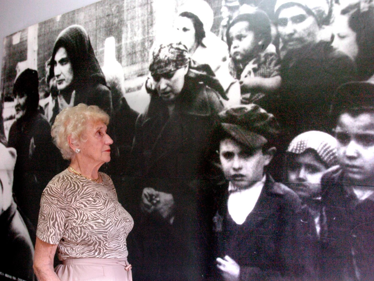 Hilda Mitchell pauses to look at one of the many photographs on the walls.
