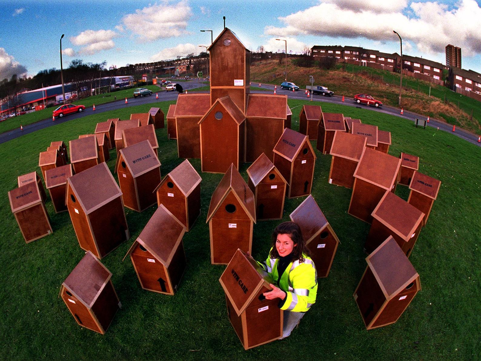 Artist Gill Russell with her Cardboard City on the Pudsey Road roundabout near Wickes.
