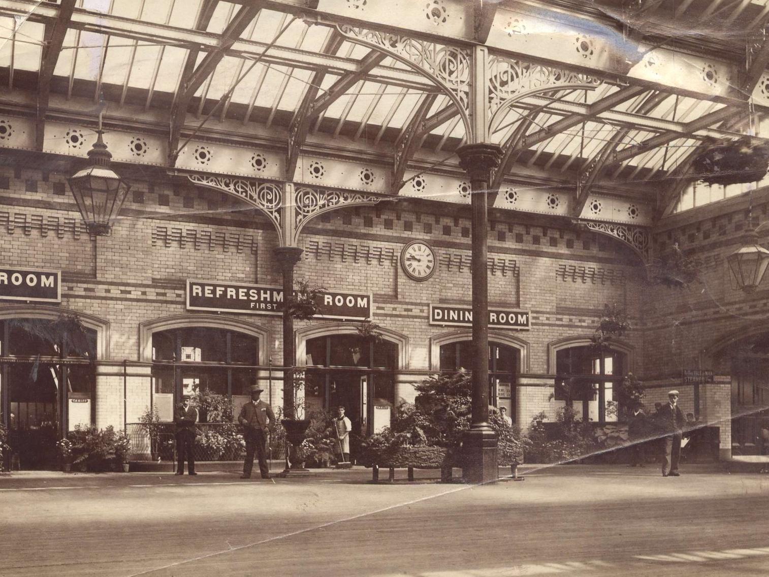 Fleetwood railway station in 1890. According to the hand-written caption on the back of the photo, from the Fleetwood Weekly News' archive, it was 9.45am. The photographer (unknown) writes: "The air is warm and the floral decoration has a summer lushness"