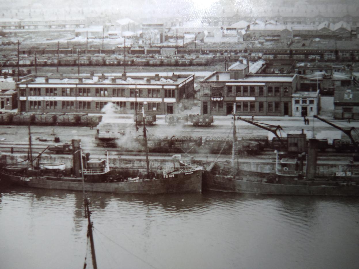A steam train rumbles alongsideWyre Dock, photo taken from the Ice House