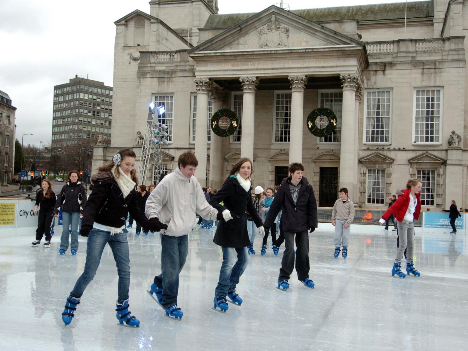 Hand in hand around the ice for these young skaters.