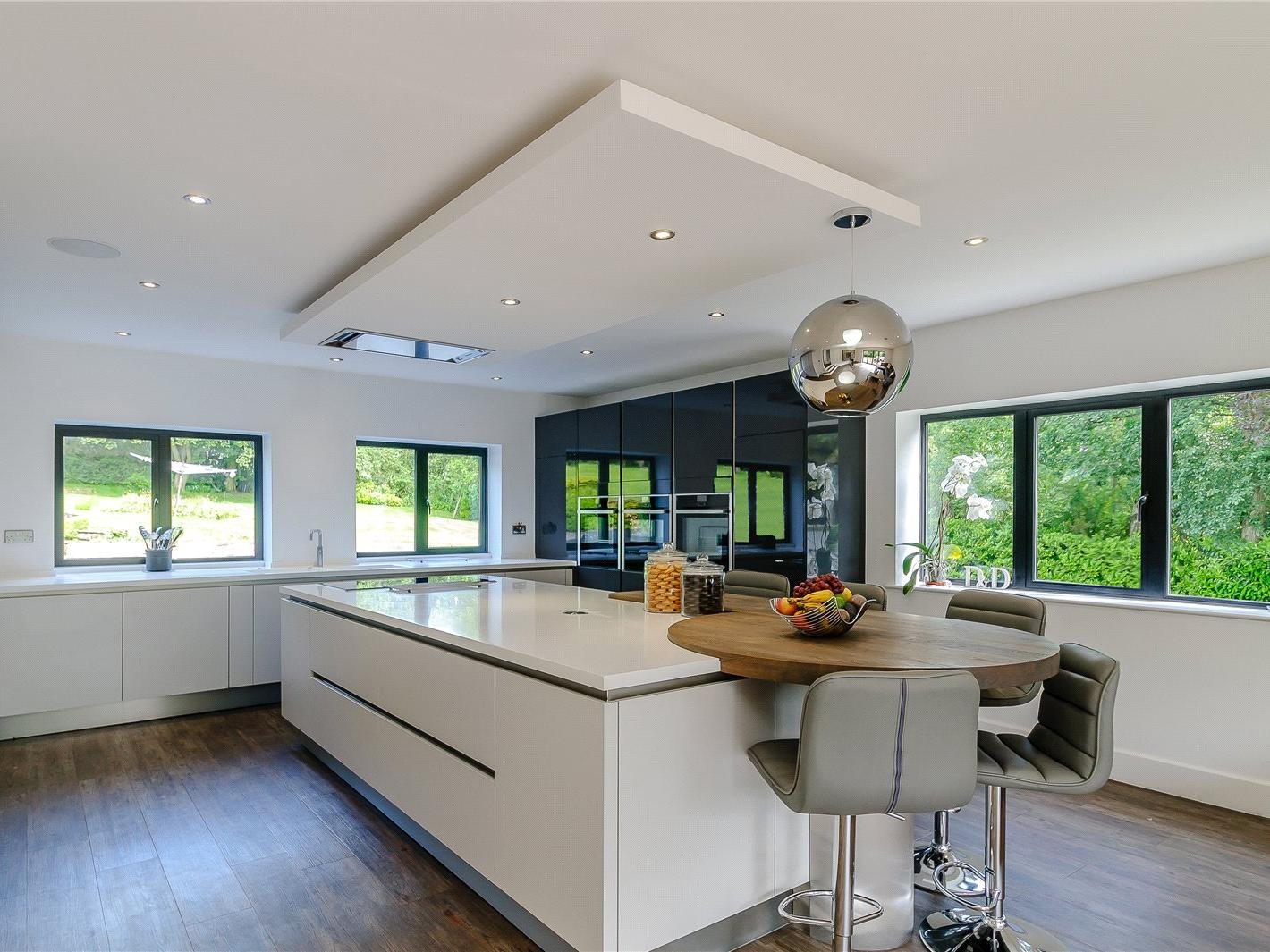 At the heart of the home is a large, newly fitted dining kitchen, which boasts a central island with a wooden breakfast bar