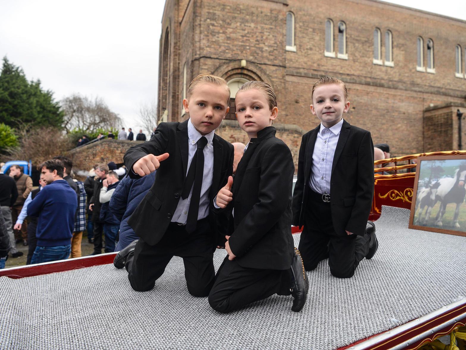 Three children were pictured on the funeral procession cc SWNS