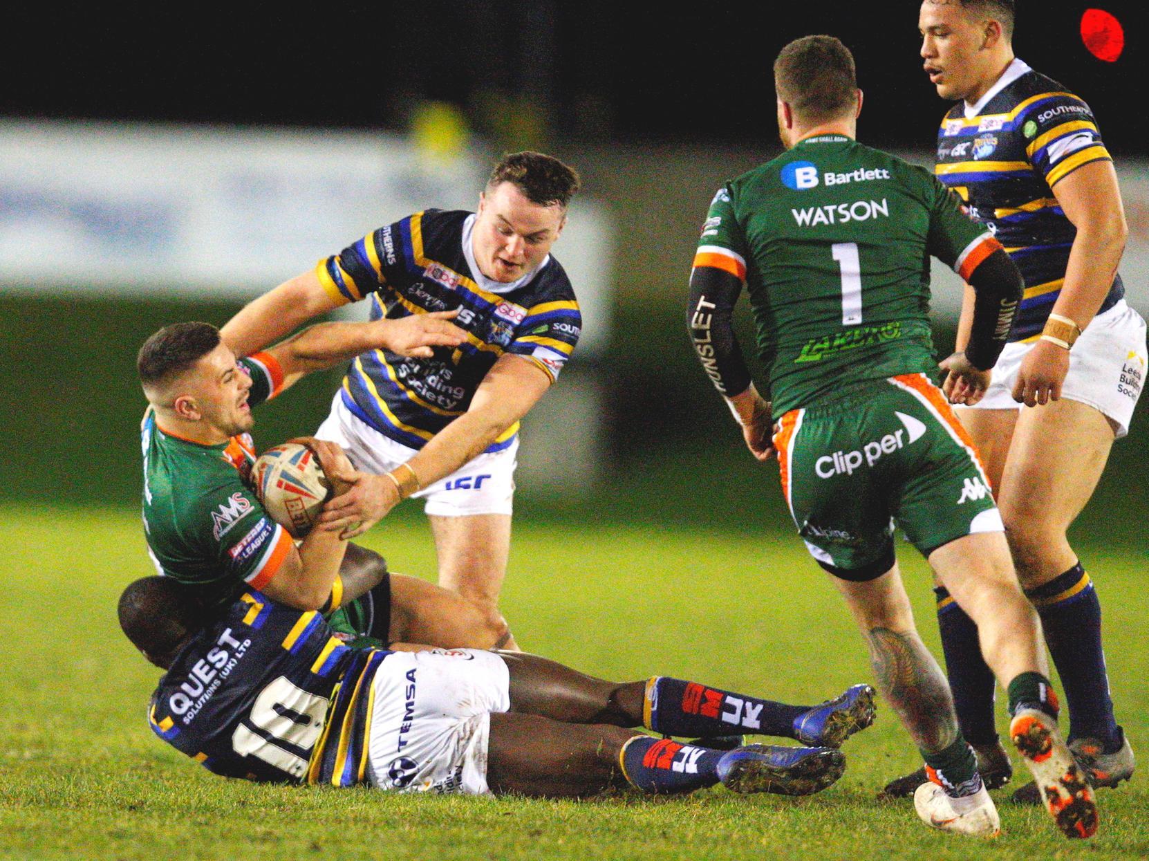 Hunslet's Vila Halafihi tackled by Muizz Mustapha and Loui McConnell. Picture by Craig Hawkhead.
