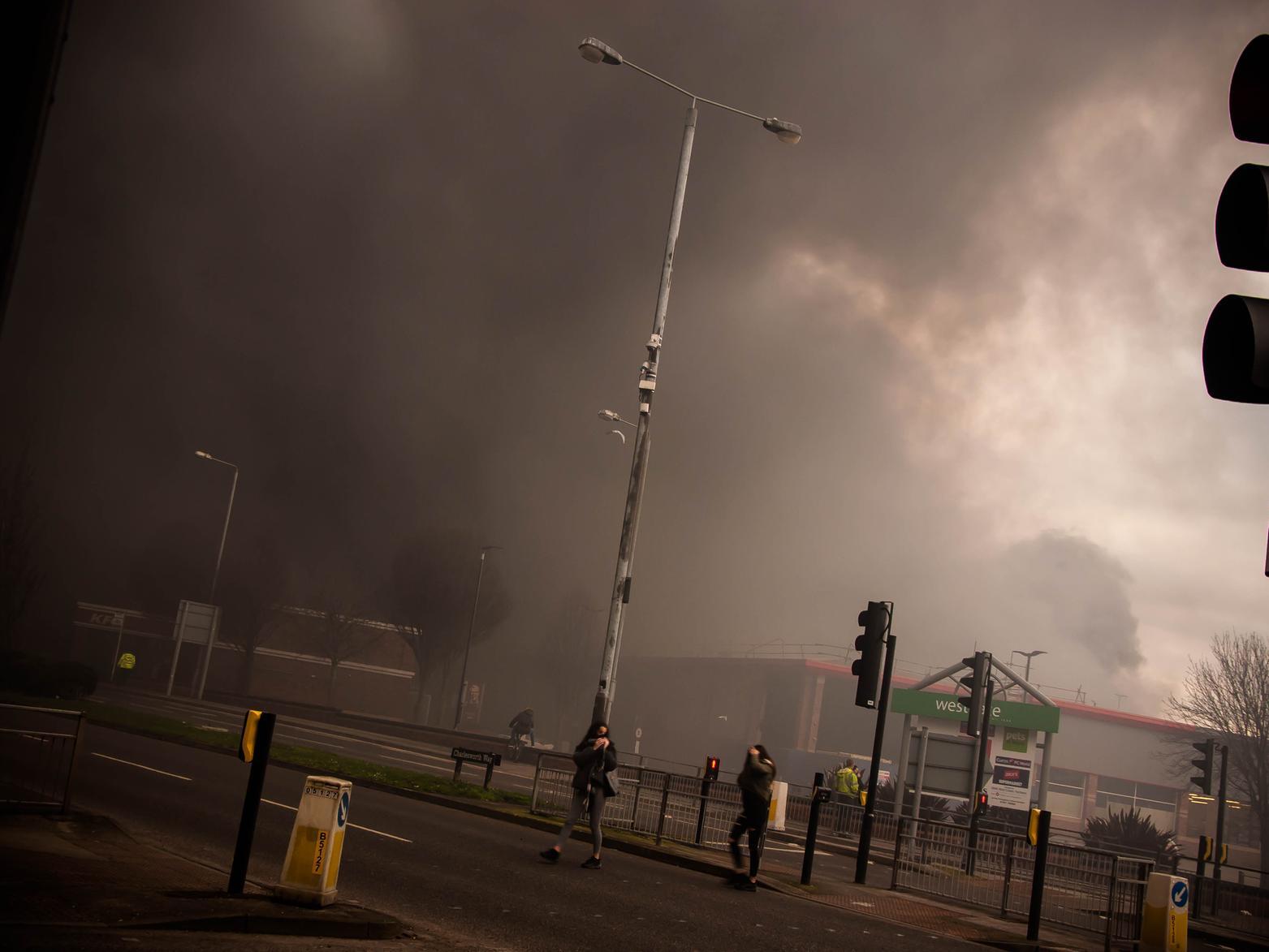 Andrew Parkinson submitted this photo, which shows members of the public covering their faces as they flee the fire.