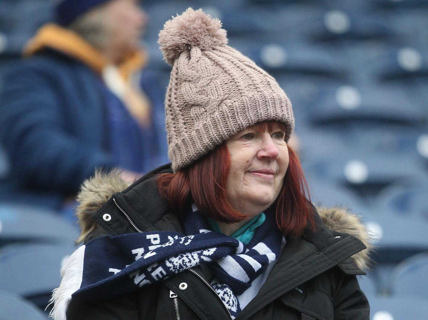One North End fan sits awaiting the players at Deepdale.