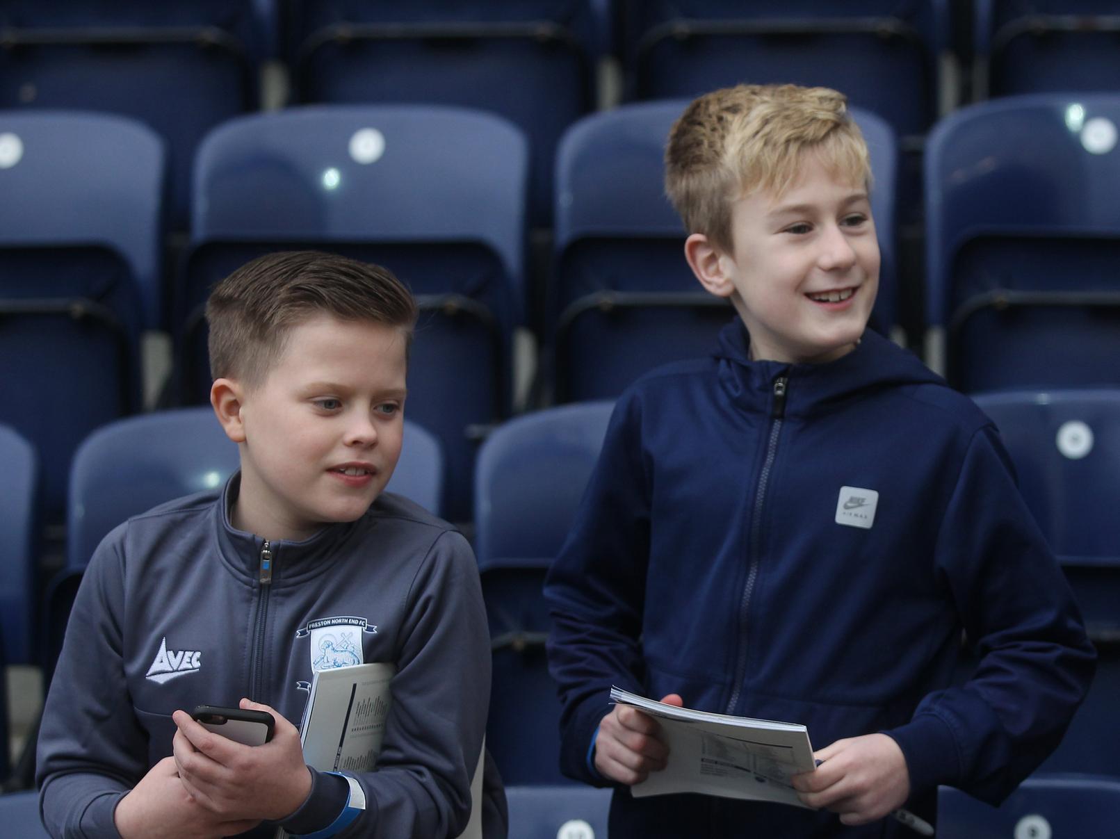 Two young North Enders smiles as something has caught their eye on the Alan Kelly Town End.