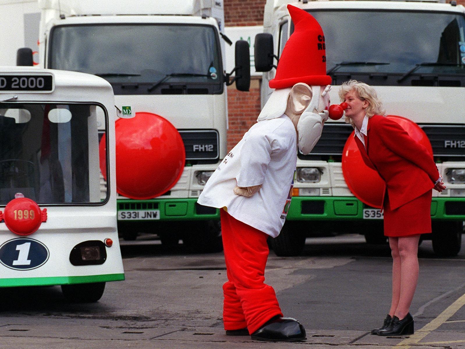 Mags McAvoy, of M.D.Foods in Leeds, greets the official Comic Relief Millennium Gnome with an Eskimo kiss on his arrival in Leeds to celebrate the delivery of 5,000 red noses for their employees.
