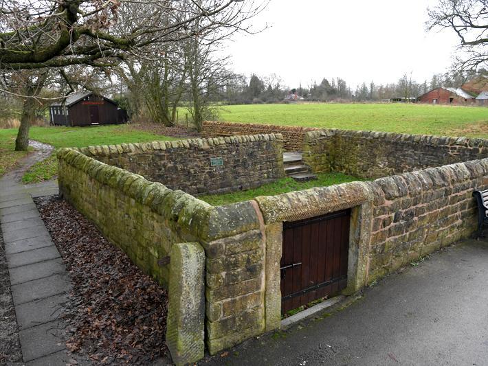 Pinfold, probably C18. Roughly-squared sandstone blocks, built to house animals found straying from their owners land or grazing somewhere without the necessary rights