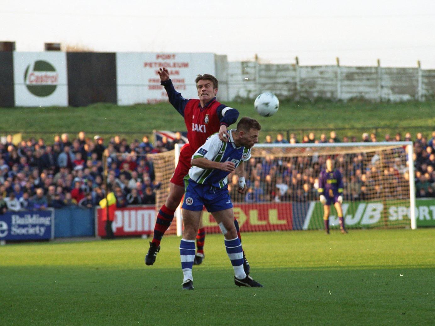 PNE right-back Gary Parkinson challenges Wigan striker Graeme Jones at Springfield Park in November 1997