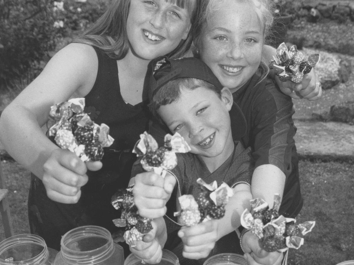 Resisting the temptation to eat the sweets are youngsters, left to right, Samantha Eblet, Beaver Joe Healy and his sister Katie who helped out on the stall at the Filey Scout Group Gala Day back in July 1997.