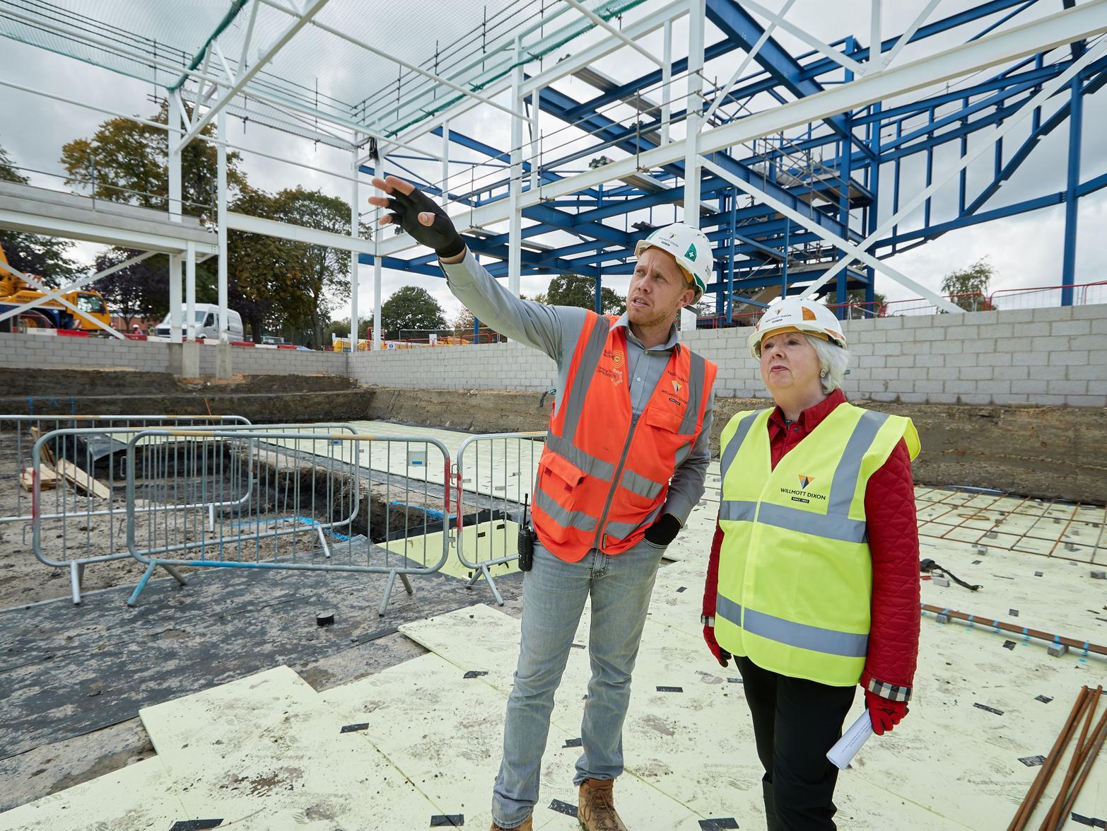 By September 2019, the frame of the building had been constructed. Pictured is Coun Jacquie Speight with build manager Paul Buckle.